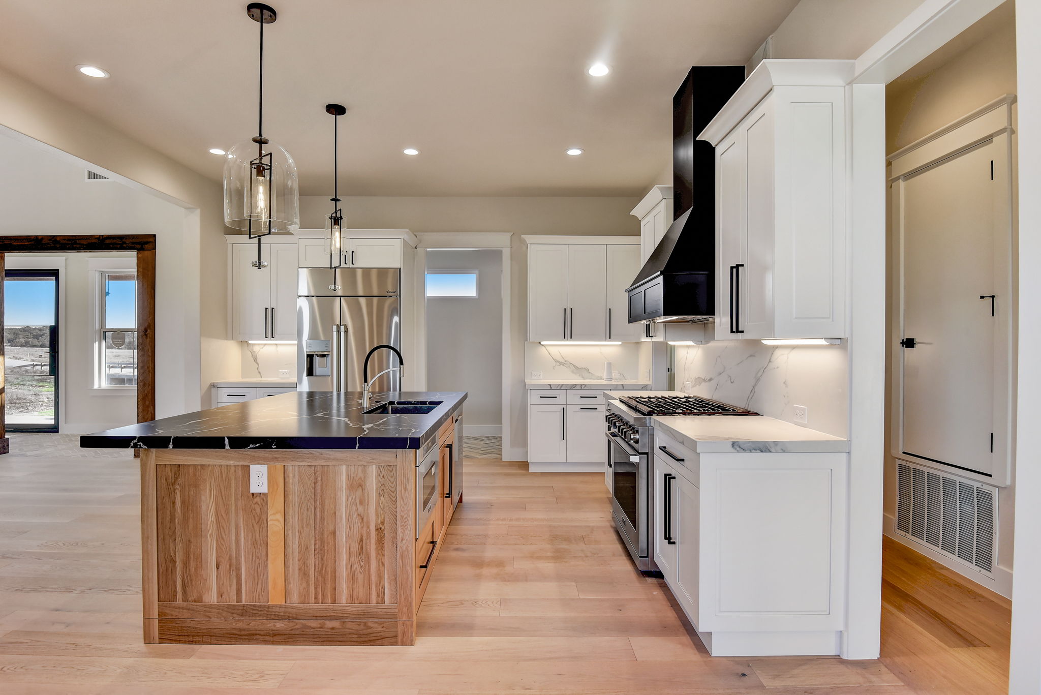 White shaker kitchen with walnut island